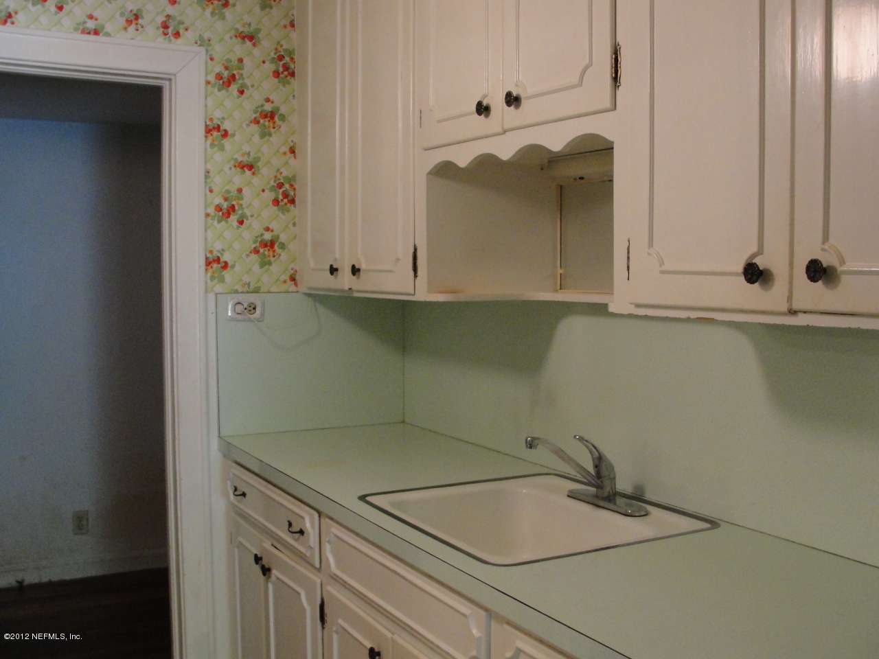 4656 Manchester Road Jacksonville, FL 32210 - Photo 10 of 31 a bathroom with a sink and cabinets