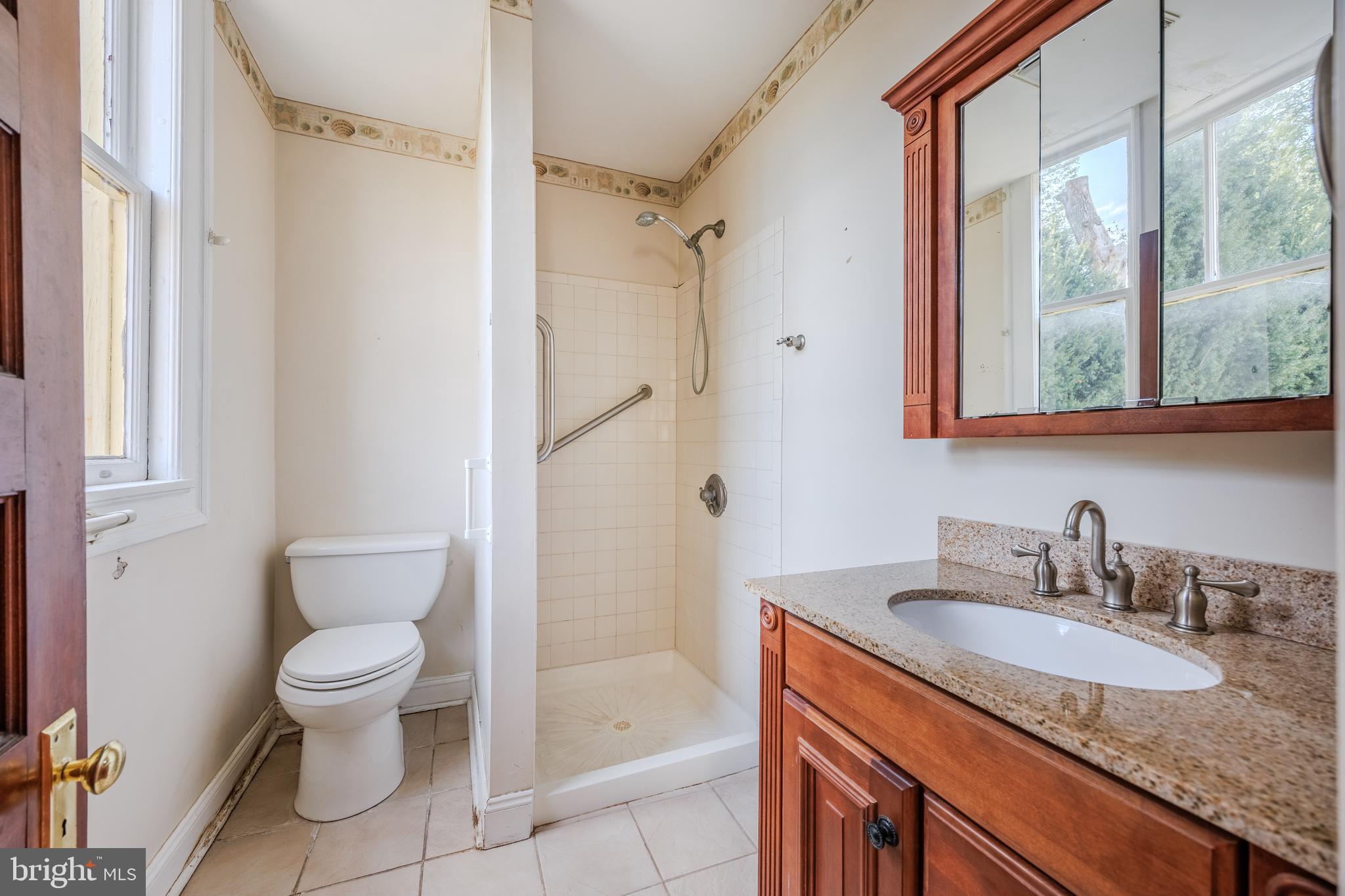242 East Main Street Elkton, MD 21921 - Photo 23 of 53 a bathroom with a granite countertop sink toilet and shower