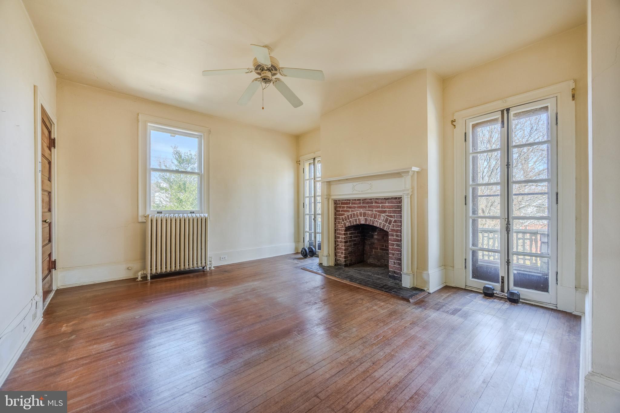 242 East Main Street Elkton, MD 21921 - Photo 31 of 53 an empty room with windows fireplace and wooden floor