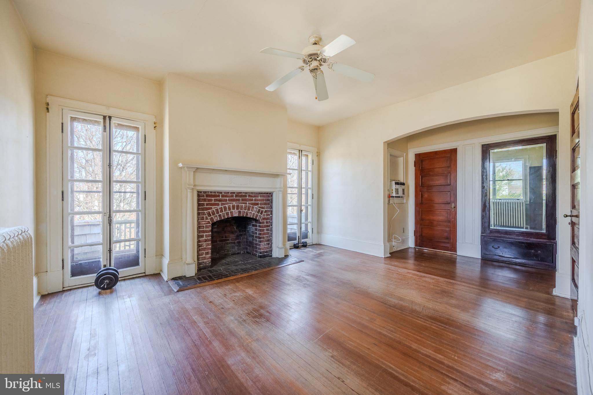 242 East Main Street Elkton, MD 21921 - Photo 32 of 53 an empty room with wooden floor fireplace and windows