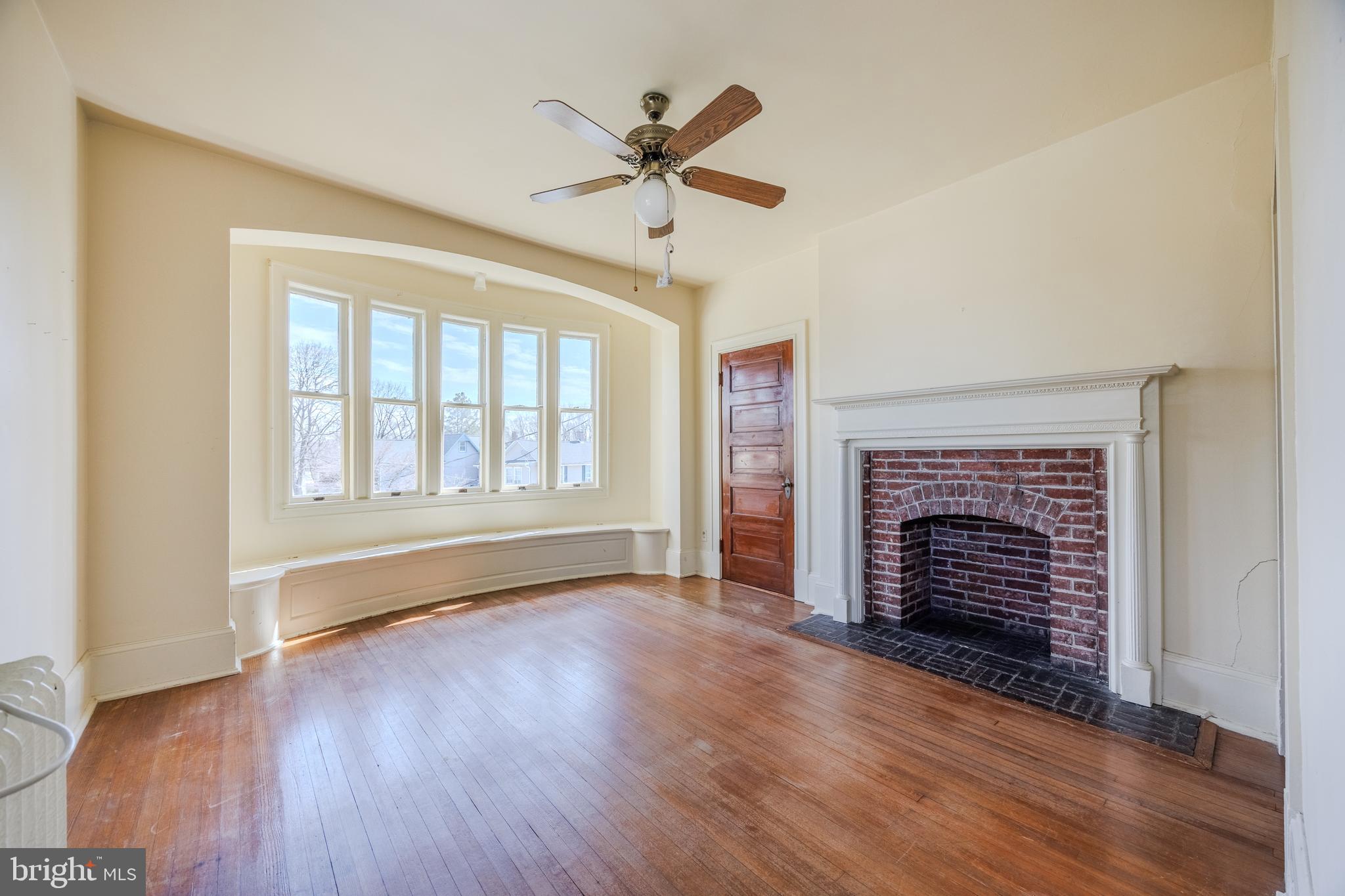 242 East Main Street Elkton, MD 21921 - Photo 36 of 53 an empty room with fireplace wooden floor and windows