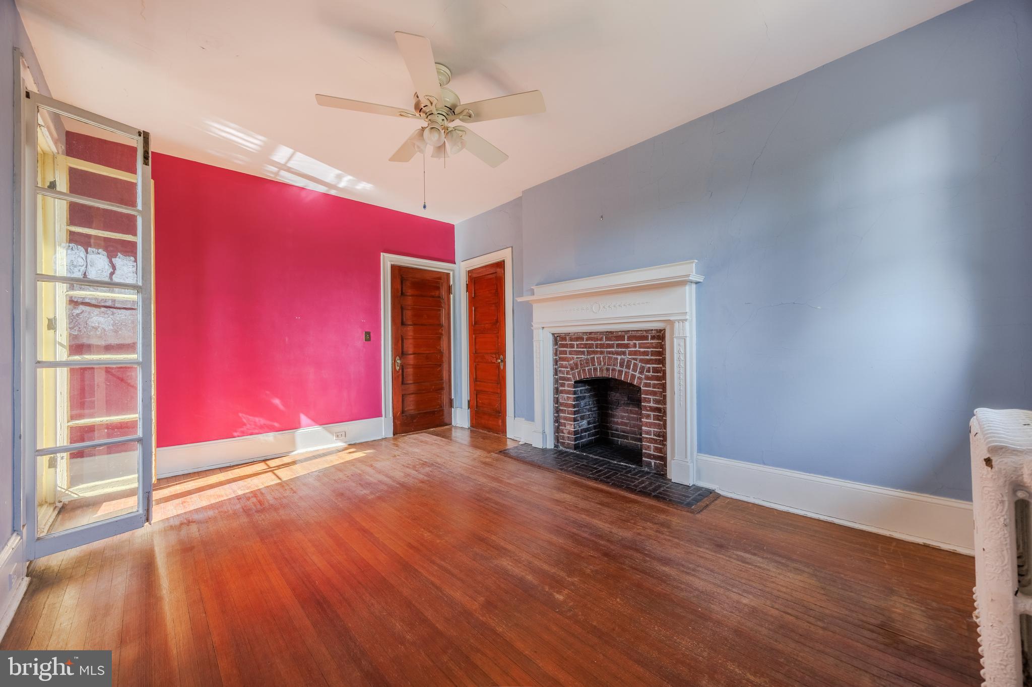242 East Main Street Elkton, MD 21921 - Photo 41 of 53 a view of an empty room with wooden floor fireplace and a window