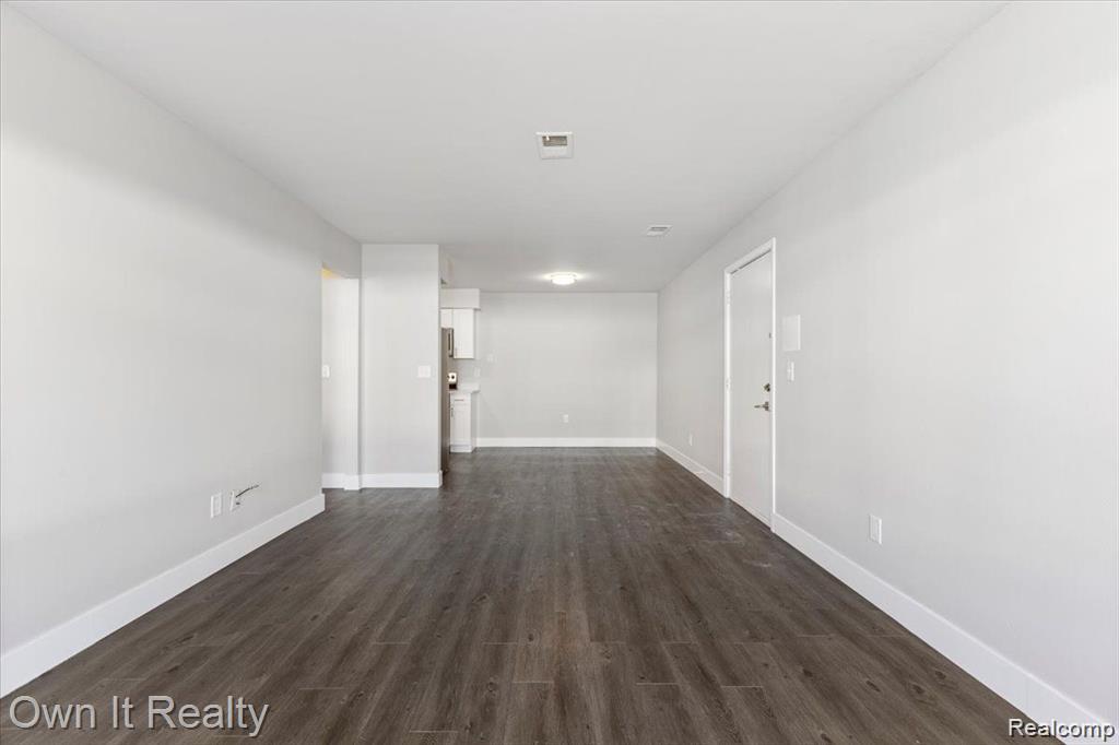 59314 Van Dyke Road Washington, MI 48094 - Photo 7 of 16 Unfurnished room featuring dark wood-style flooring and baseboards