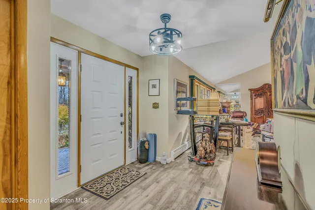 a view of a livingroom with furniture and a hallway