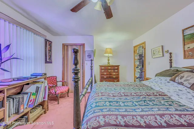 a bedroom with a bed a dresser and book shelf