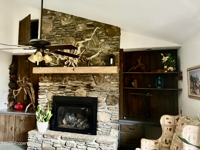 a living room with a fireplace and a wooden floor