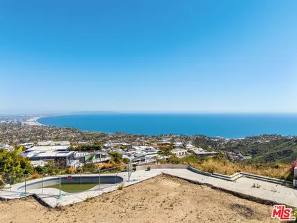 an aerial view of residential building and ocean view