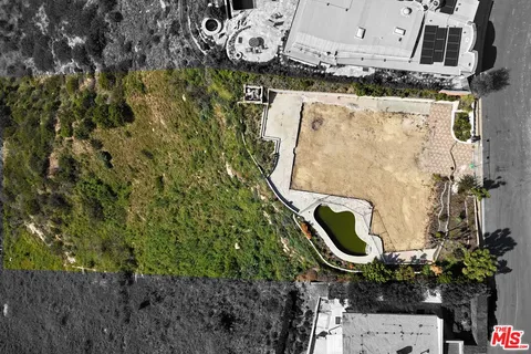 an aerial view of a house with a backyard