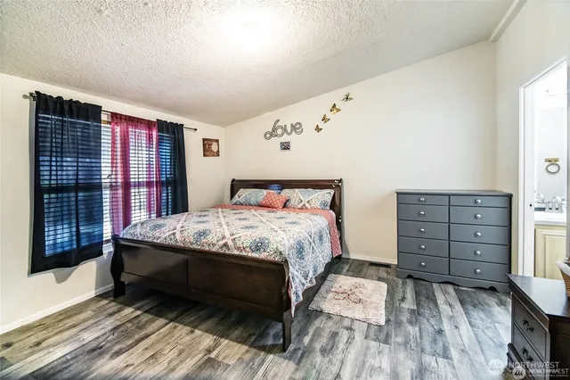 a bedroom with a large bed and a dresser