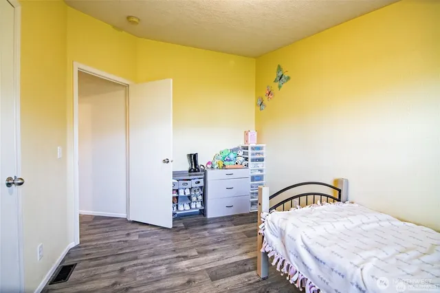 a bedroom with a bed and a dresser