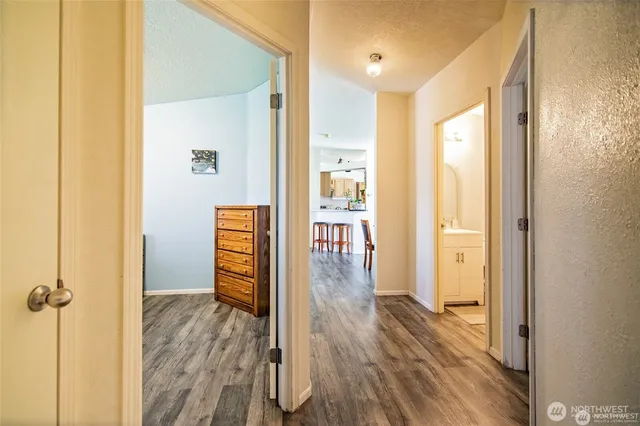 a view of a hallway view with wooden floor and staircase