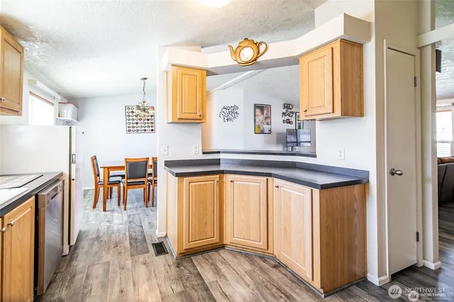 a kitchen with stainless steel appliances granite countertop wooden cabinets a sink and dishwasher