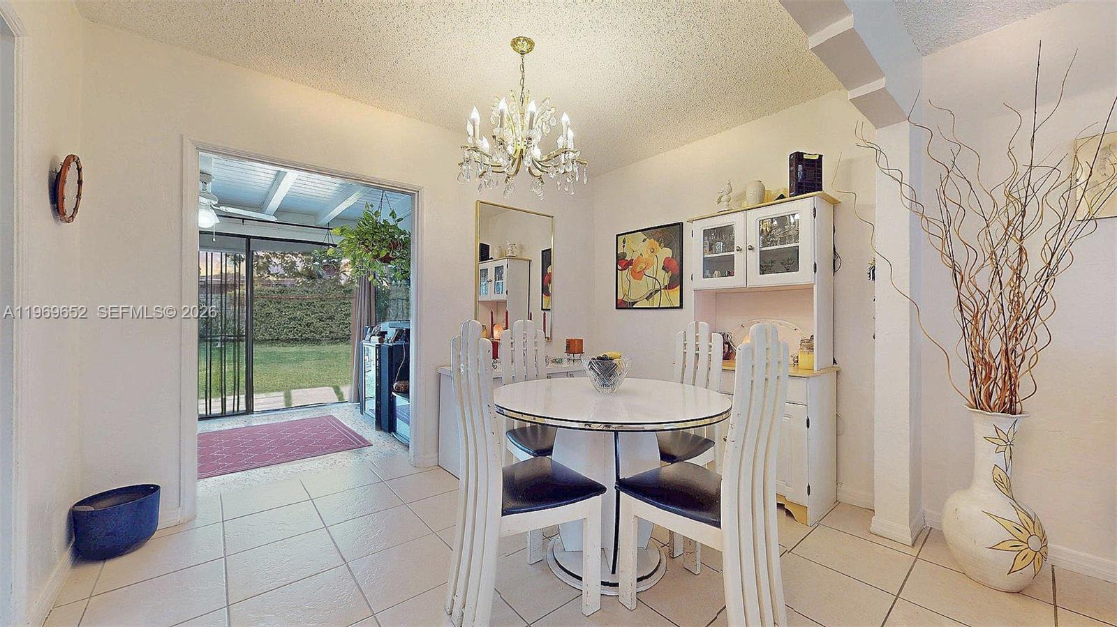 1611 Southwest 21st Street Miami, FL 33145 - Photo 11 of 59 a view of a dining room with furniture a chandelier and window