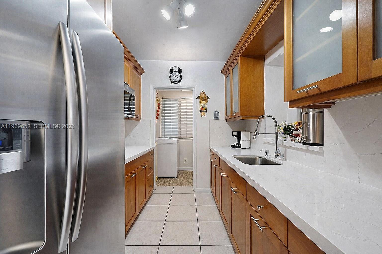 1611 Southwest 21st Street Miami, FL 33145 - Photo 12 of 59 a kitchen with stainless steel appliances granite countertop a sink a refrigerator and a stove