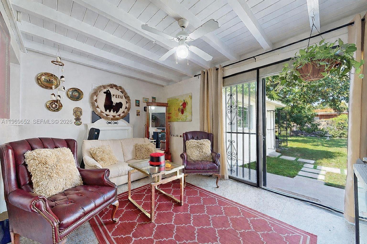 1611 Southwest 21st Street Miami, FL 33145 - Photo 16 of 59 a living room with patio furniture and a floor to ceiling window