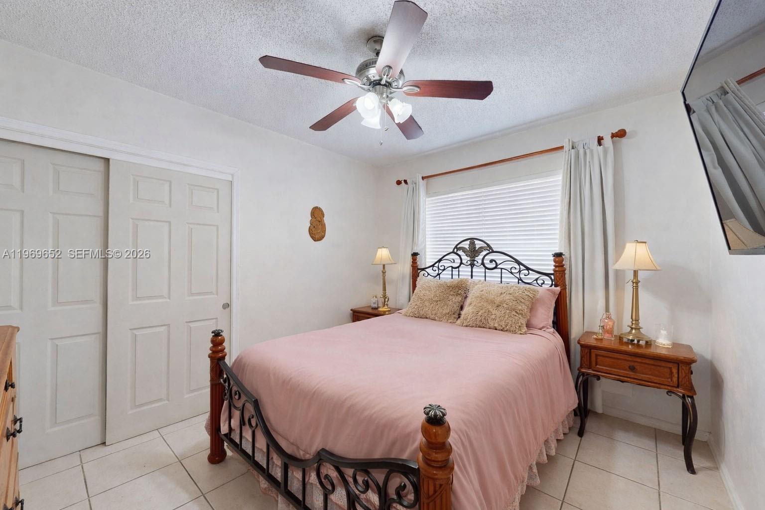 1611 Southwest 21st Street Miami, FL 33145 - Photo 18 of 59 a bedroom with a bed and a chandelier