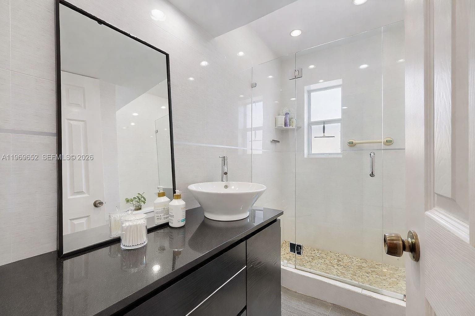 1611 Southwest 21st Street Miami, FL 33145 - Photo 19 of 59 a bathroom with a granite countertop sink a toilet and shower