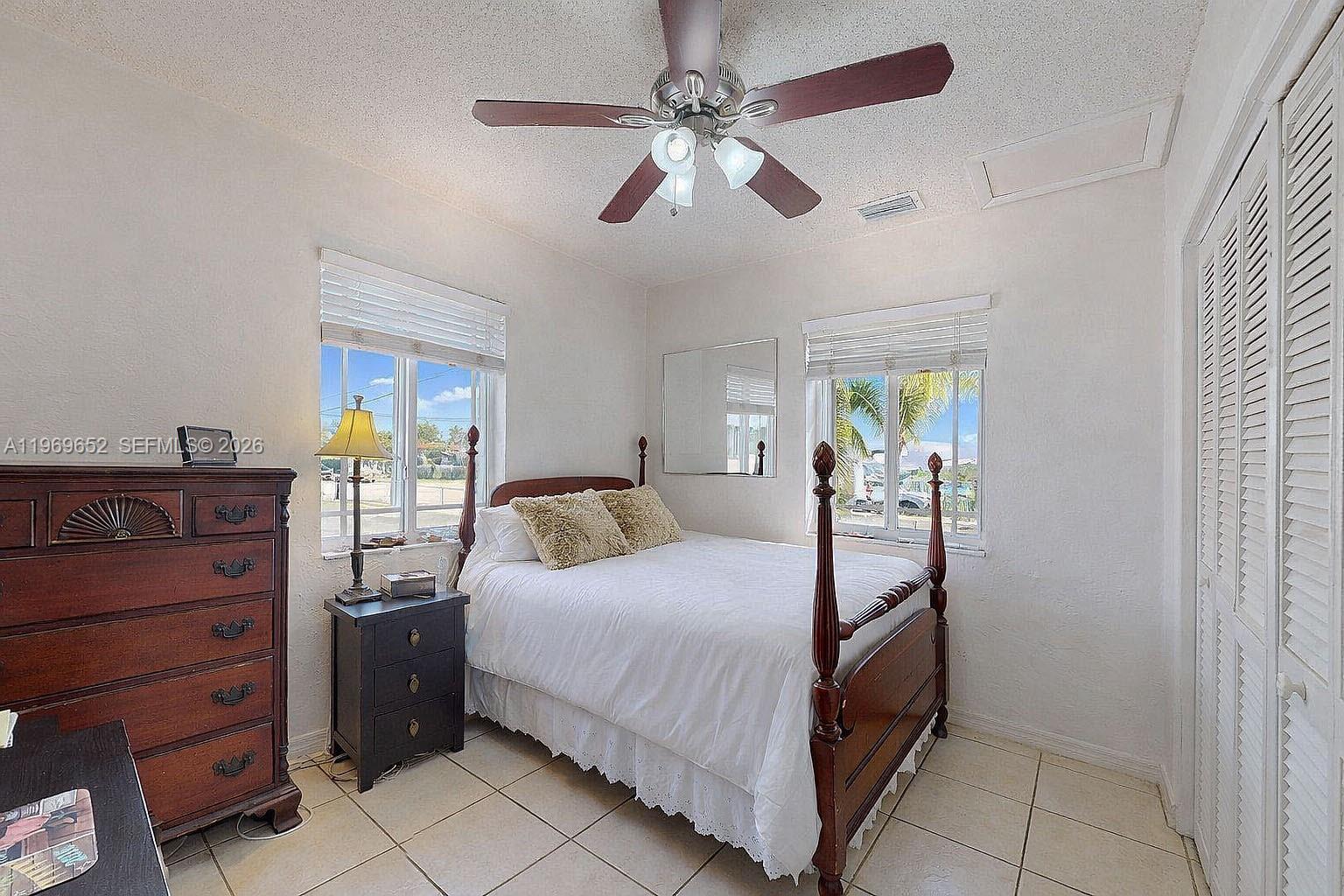 1611 Southwest 21st Street Miami, FL 33145 - Photo 22 of 59 a bedroom with a bed and ceiling fan