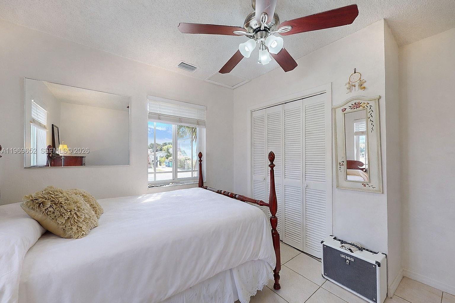 1611 Southwest 21st Street Miami, FL 33145 - Photo 23 of 59 a bedroom with a bed and a chandelier