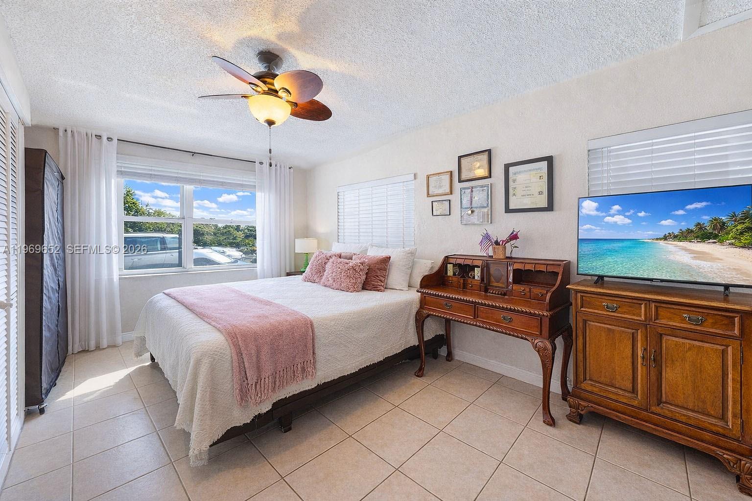 1611 Southwest 21st Street Miami, FL 33145 - Photo 24 of 59 a bedroom with a bed and a chandelier