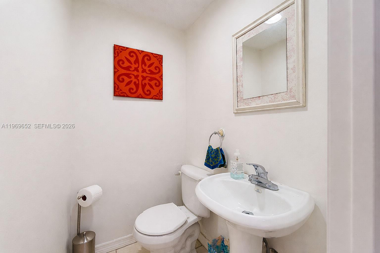 1611 Southwest 21st Street Miami, FL 33145 - Photo 26 of 59 a bathroom with a toilet sink and mirror