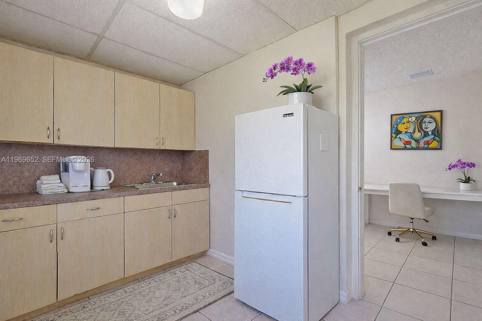 1611 Southwest 21st Street Miami, FL 33145 - Photo 29 of 59 a kitchen with cabinets a refrigerator and a sink