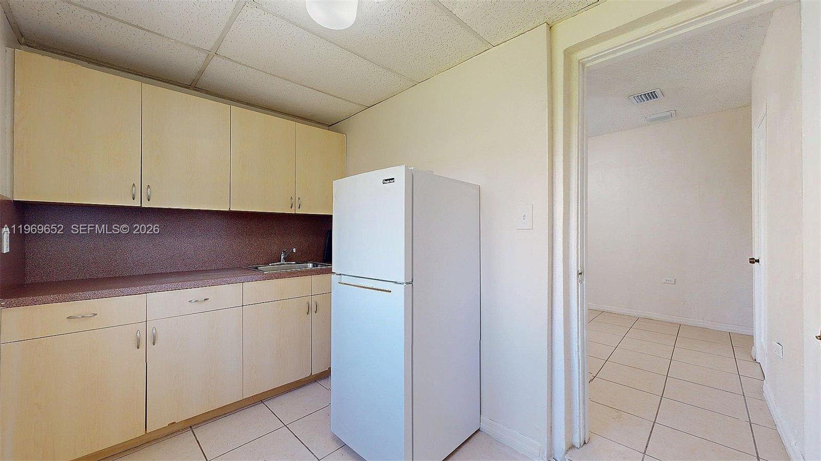 1611 Southwest 21st Street Miami, FL 33145 - Photo 30 of 59 a kitchen with stainless steel appliances a refrigerator and cabinets