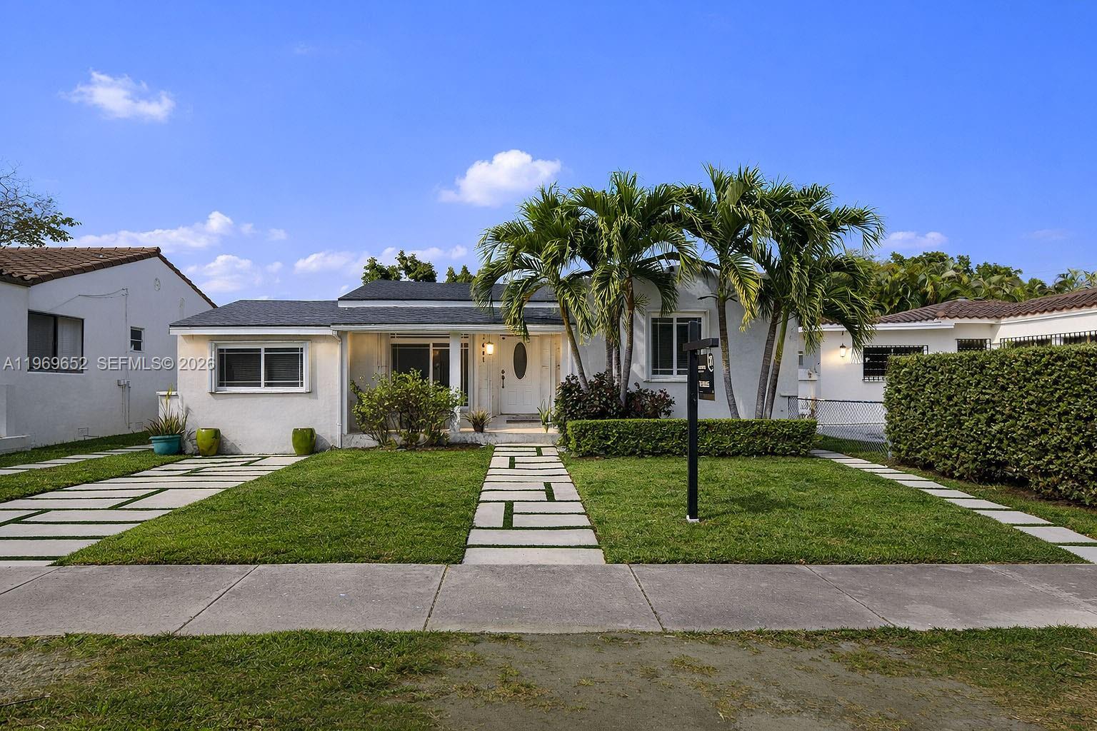 1611 Southwest 21st Street Miami, FL 33145 - Photo 3 of 59 a front view of a house with a garden and yard