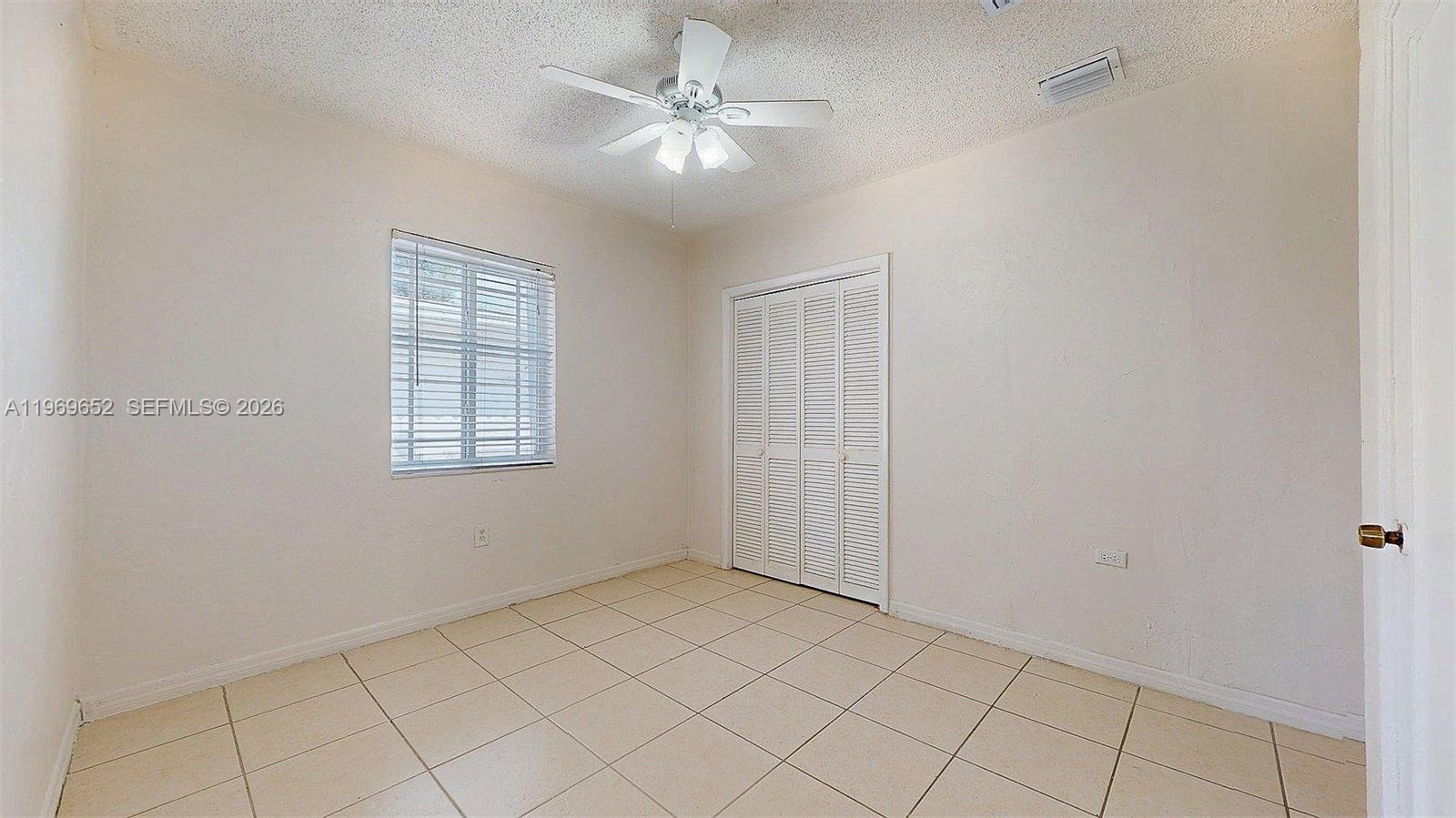 1611 Southwest 21st Street Miami, FL 33145 - Photo 32 of 59 an empty room with windows and fan