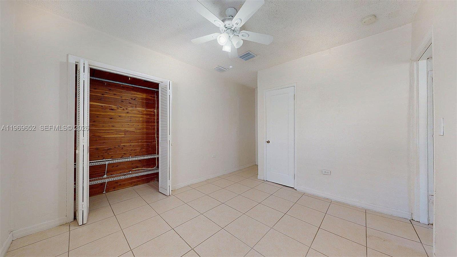 1611 Southwest 21st Street Miami, FL 33145 - Photo 33 of 59 an empty room with closet and a ceiling fan