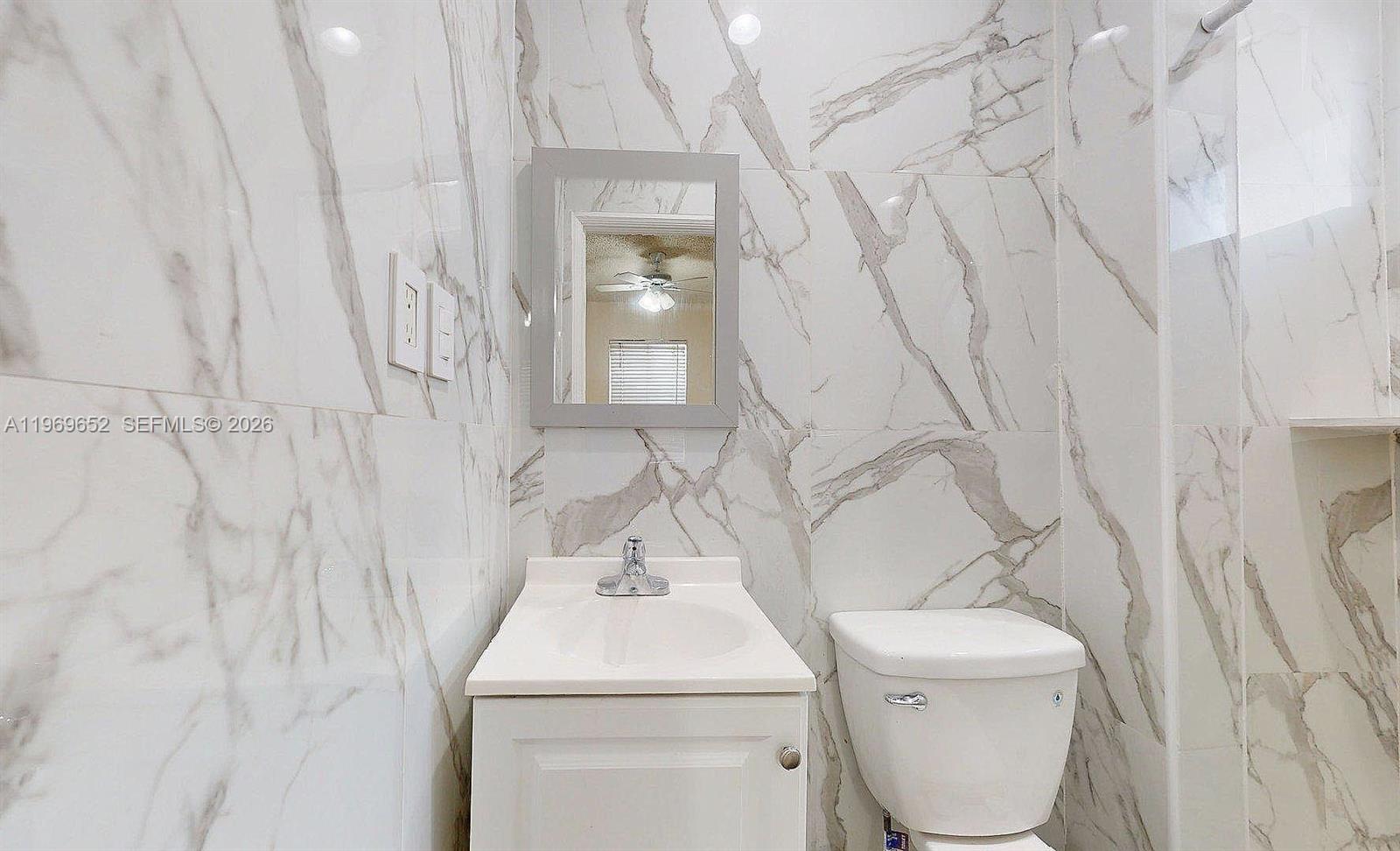 1611 Southwest 21st Street Miami, FL 33145 - Photo 34 of 59 a bathroom with a toilet sink and mirror