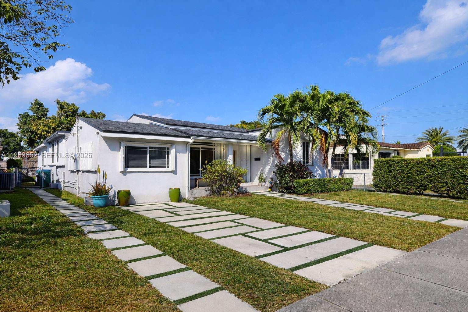 1611 Southwest 21st Street Miami, FL 33145 - Photo 4 of 59 a front view of a house with a yard
