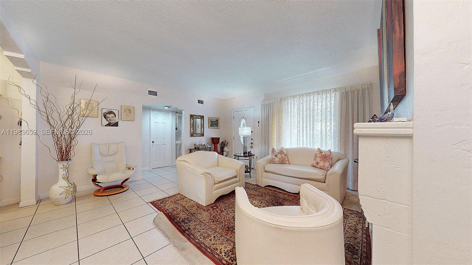 1611 Southwest 21st Street Miami, FL 33145 - Photo 7 of 59 a living room with furniture and a fireplace