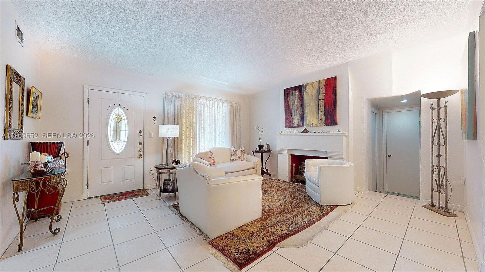 1611 Southwest 21st Street Miami, FL 33145 - Photo 8 of 59 a living room with furniture a fireplace and gym equipment