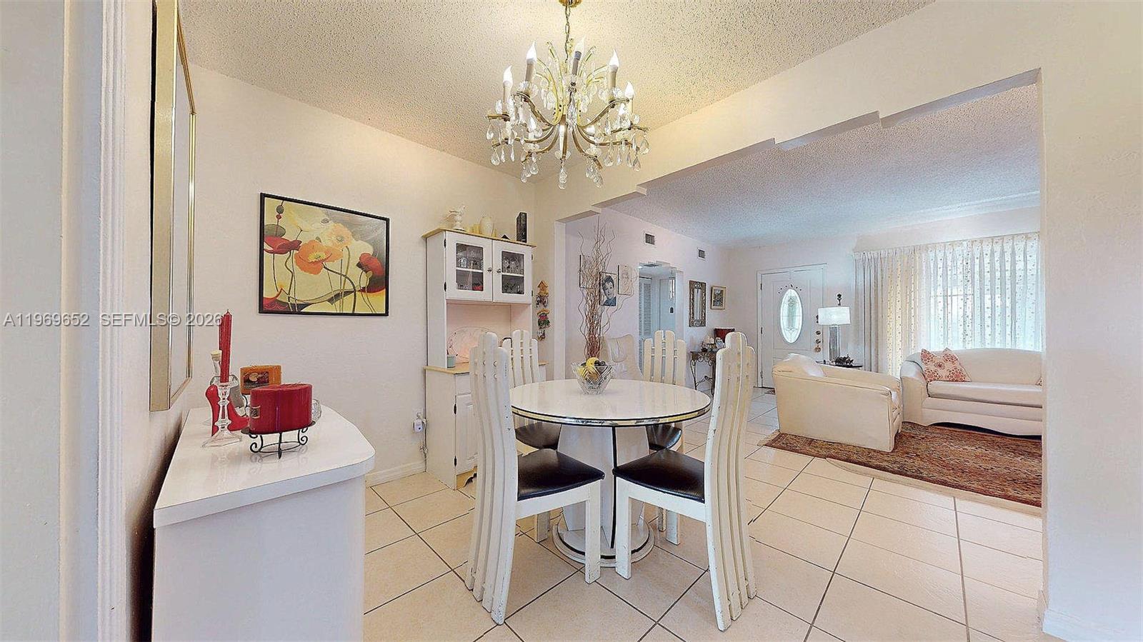 1611 Southwest 21st Street Miami, FL 33145 - Photo 10 of 59 a living room with furniture and a chandelier