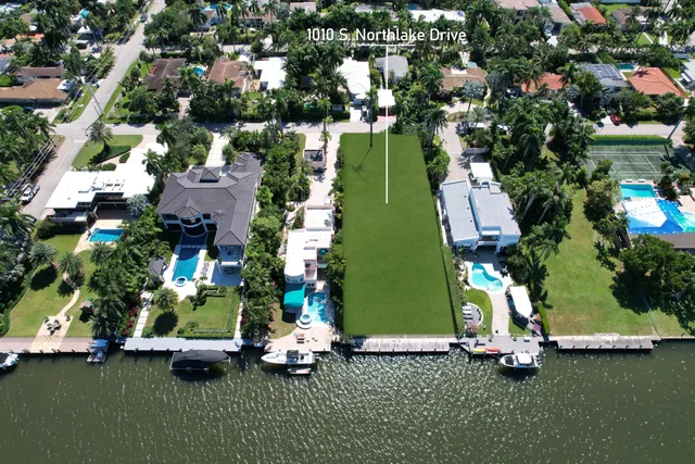 an aerial view of a house with yard garage and outdoor seating