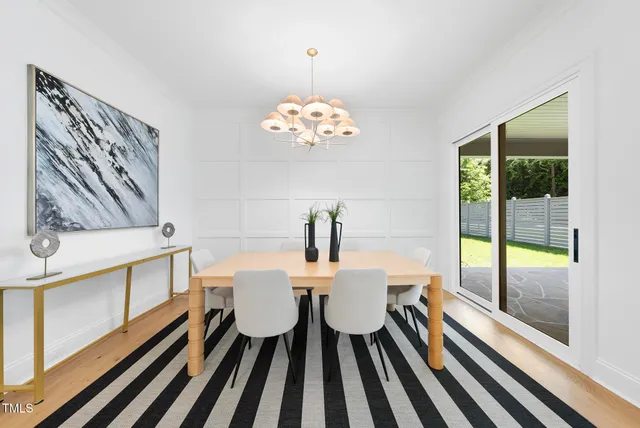 a living room with furniture fireplace and a large window