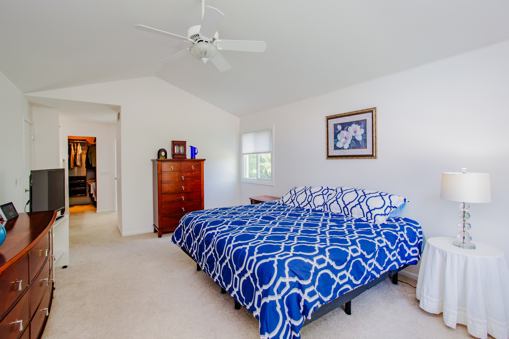 608 Raintree Road Buffalo Grove, IL 60089 - Photo 36 of 59 a bedroom with a large bed and a chandelier