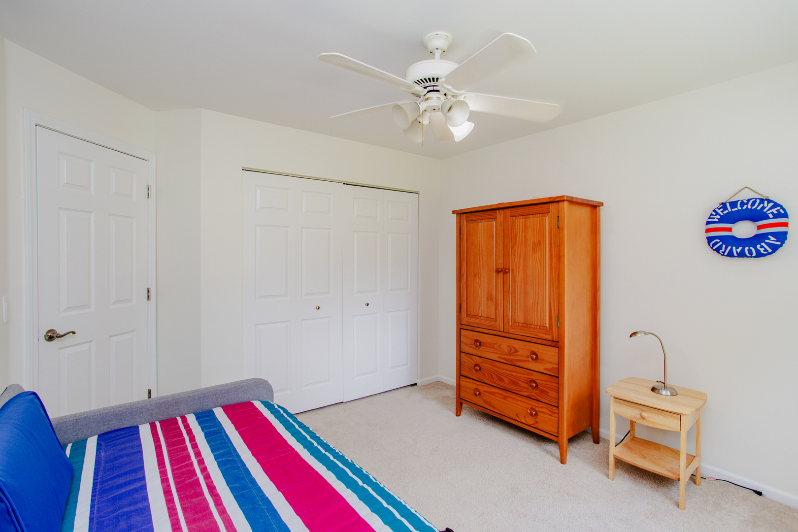 608 Raintree Road Buffalo Grove, IL 60089 - Photo 41 of 59 a room with a bed and a chandelier