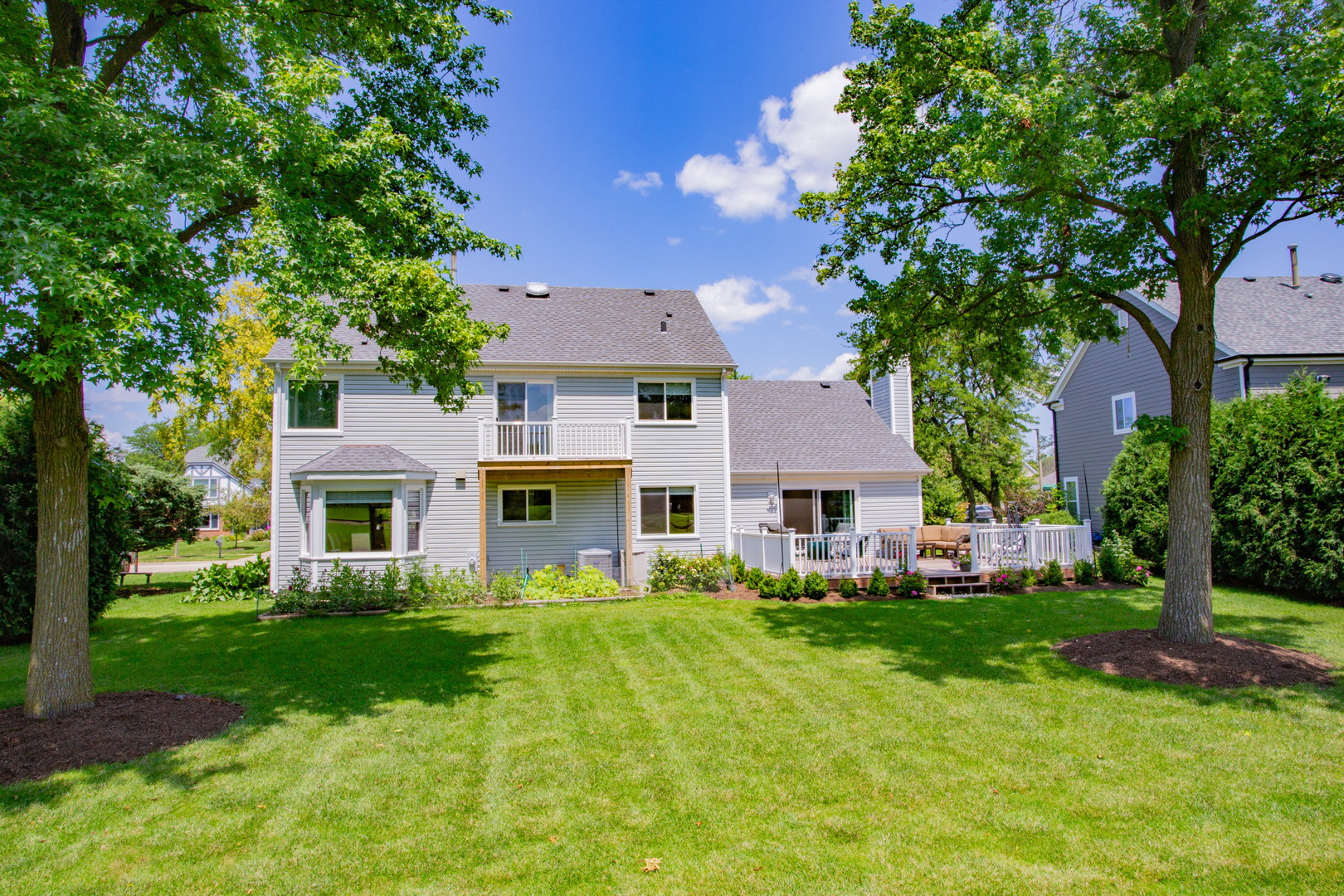 608 Raintree Road Buffalo Grove, IL 60089 - Photo 8 of 59 a front view of a house with a garden and trees