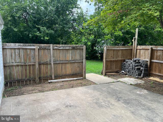 1410 Colchester Road Woodbridge, VA 22191 - Photo 17 of 19 a view of backyard with wooden fence and trees