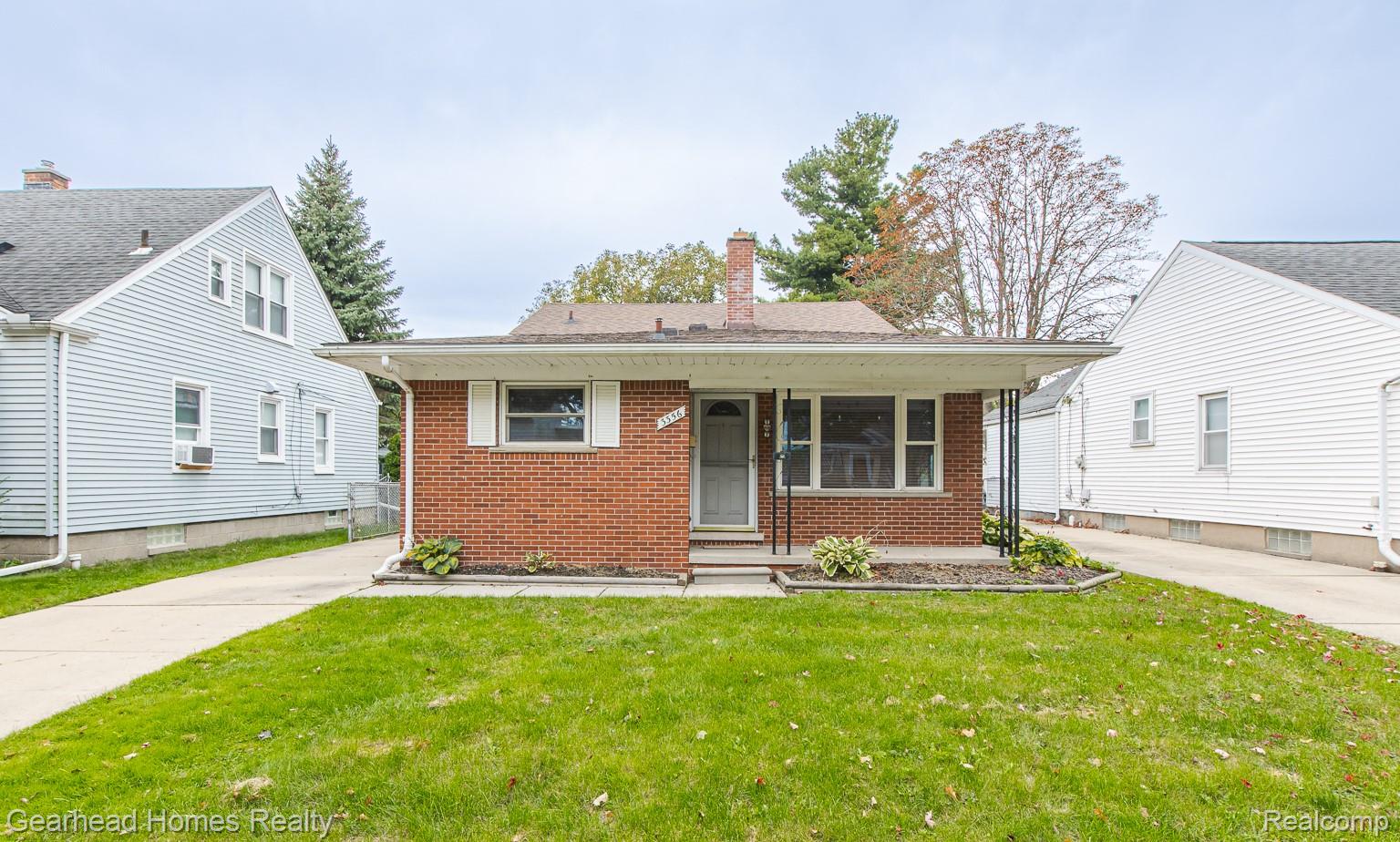 3356 Harding Street Dearborn, MI 48124 - Photo 2 of 48 Brick facade with a covered entry, established landscaping, and a concrete driveway