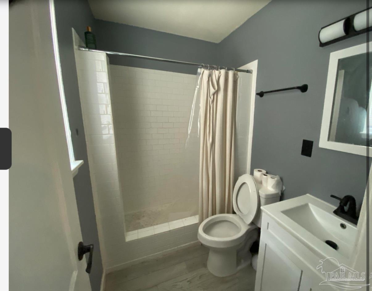 902 Decatur Avenue Pensacola, FL 32507 - Photo 3 of 10 a bathroom with a sink and a mirror