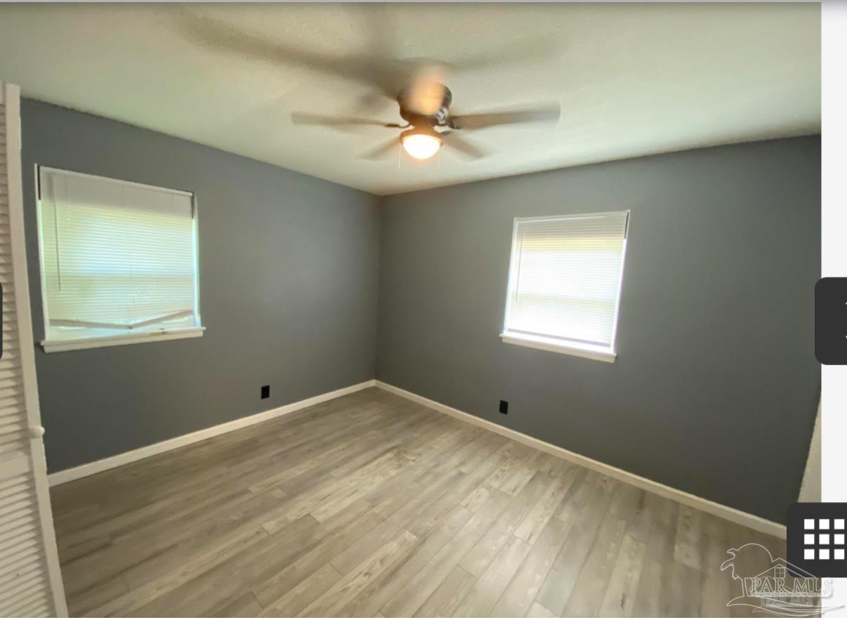 902 Decatur Avenue Pensacola, FL 32507 - Photo 5 of 10 a view of an empty room with a window