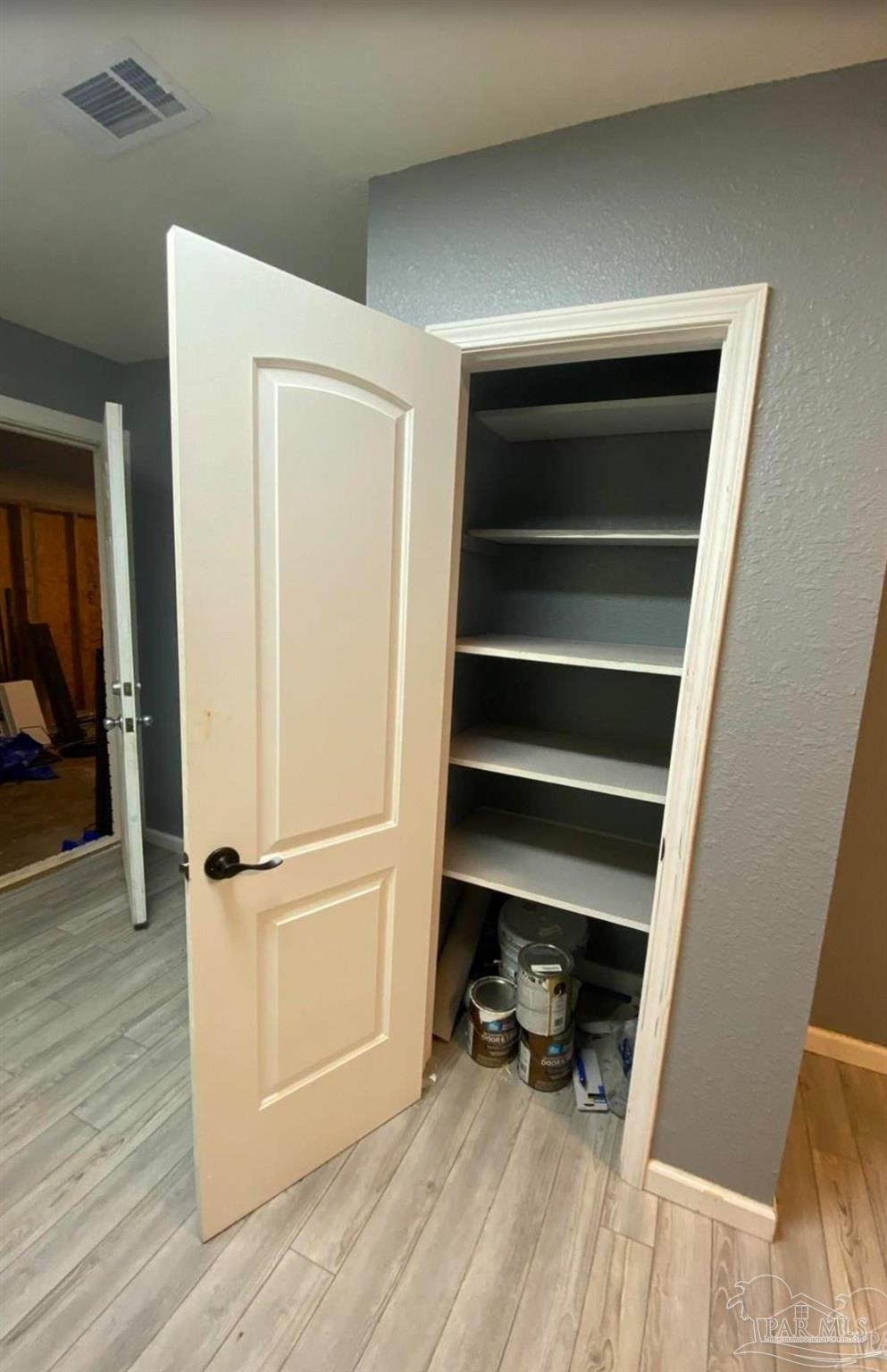 902 Decatur Avenue Pensacola, FL 32507 - Photo 6 of 10 a view of walk in closet with wooden floor and a chair
