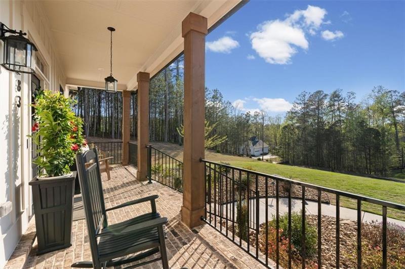 283 London Road Ball Ground, GA 30107 - Photo 12 of 73 a view of a balcony with wooden floor and iron fence