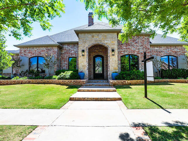 4805 116th Street Lubbock, TX 79424 - Photo 1 of 57 a front view of a house with a garden