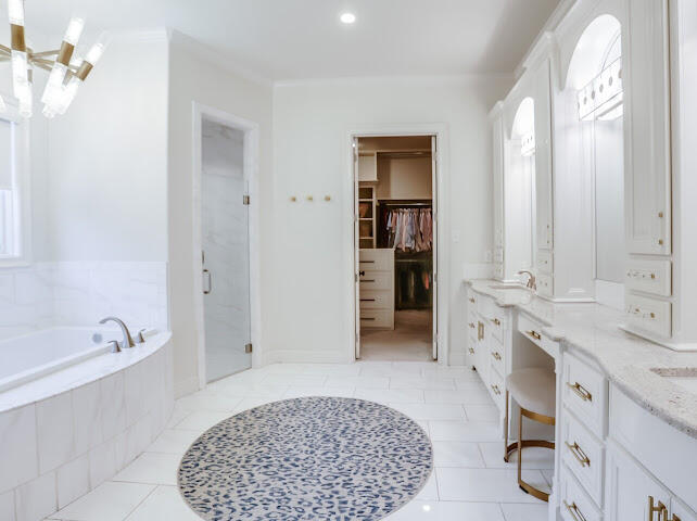 4805 116th Street Lubbock, TX 79424 - Photo 18 of 57 a spacious bathroom with a tub sink and mirror