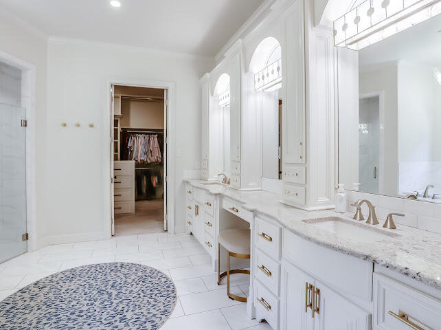 4805 116th Street Lubbock, TX 79424 - Photo 19 of 57 a spacious bathroom with a granite countertop sink and a mirror