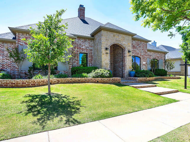 4805 116th Street Lubbock, TX 79424 - Photo 2 of 57 a front view of a house with a yard
